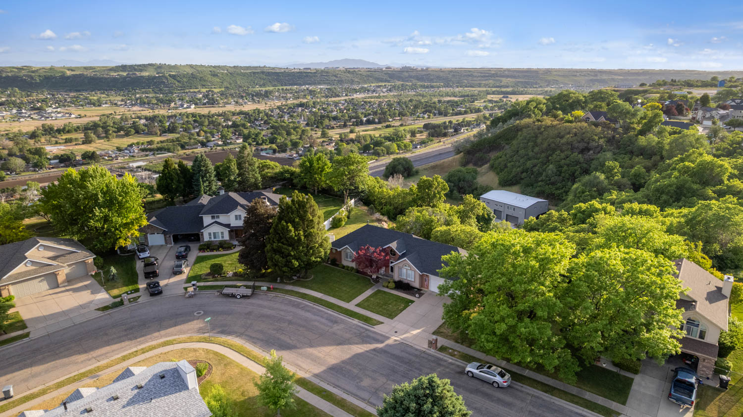 Residential street featuring a cul-de-sac and multiple single-family homes