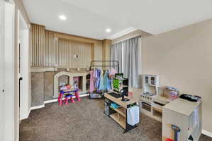 Wall-to-wall carpeting and recessed lighting define this versatile room