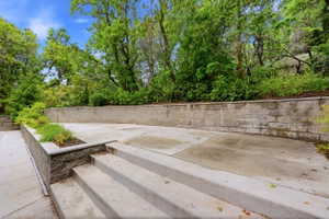 Tiered concrete patio featuring block retaining walls