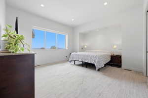 Bright interior space featuring a wide window, recessed ceiling lighting, and light-toned flooring