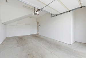 Spacious garage featuring concrete flooring and white painted walls