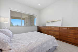 Spacious room featuring a wide horizontal window, recessed lighting, and light-toned flooring