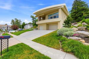 Contemporary stucco exterior with a curved roofline and upper-level balcony