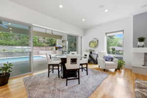 Open-concept living area with large sliding glass doors, recessed lighting, and wood-finish flooring
