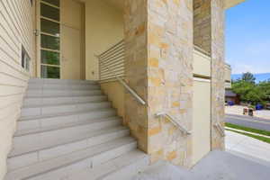 Stone veneer exterior with light siding features a grand entryway