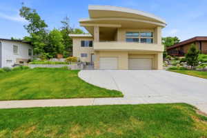 Contemporary stucco exterior featuring a curved upper facade