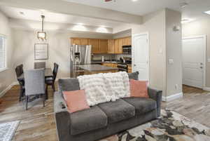 Open-concept living area featuring wood-finish flooring, recessed lighting, and a neutral wall palette