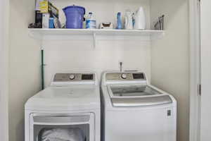 Dedicated laundry area featuring a white built-in shelf