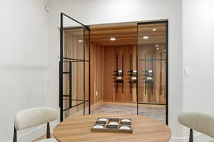 Custom wine cellar featuring wood paneling and stone tile flooring