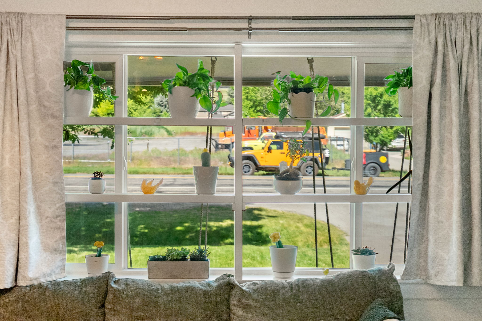 Expansive multi-pane window with white framing and integrated shelving