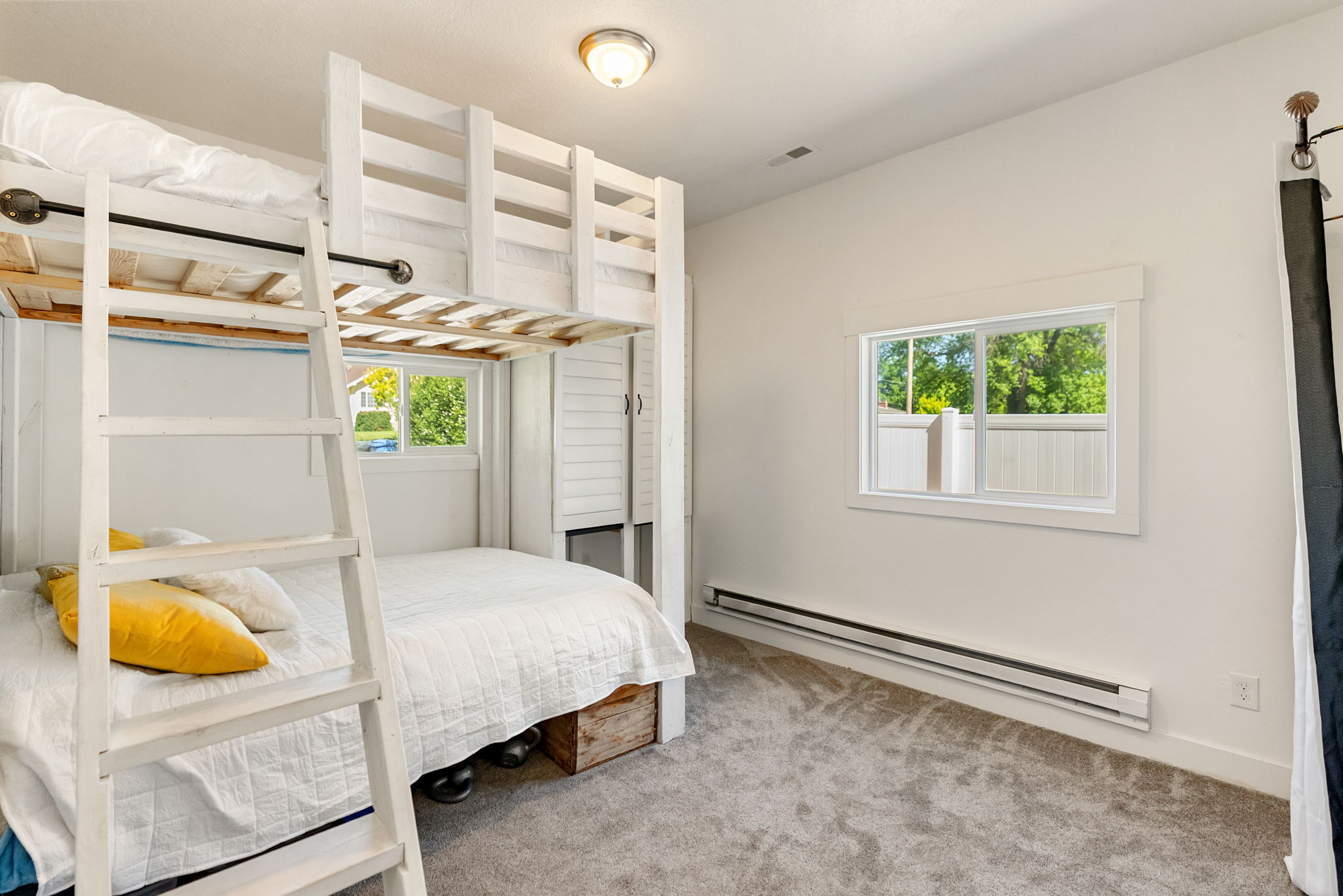 Room featuring a built-in bunk bed structure with a white finish, carpet flooring, and white walls
