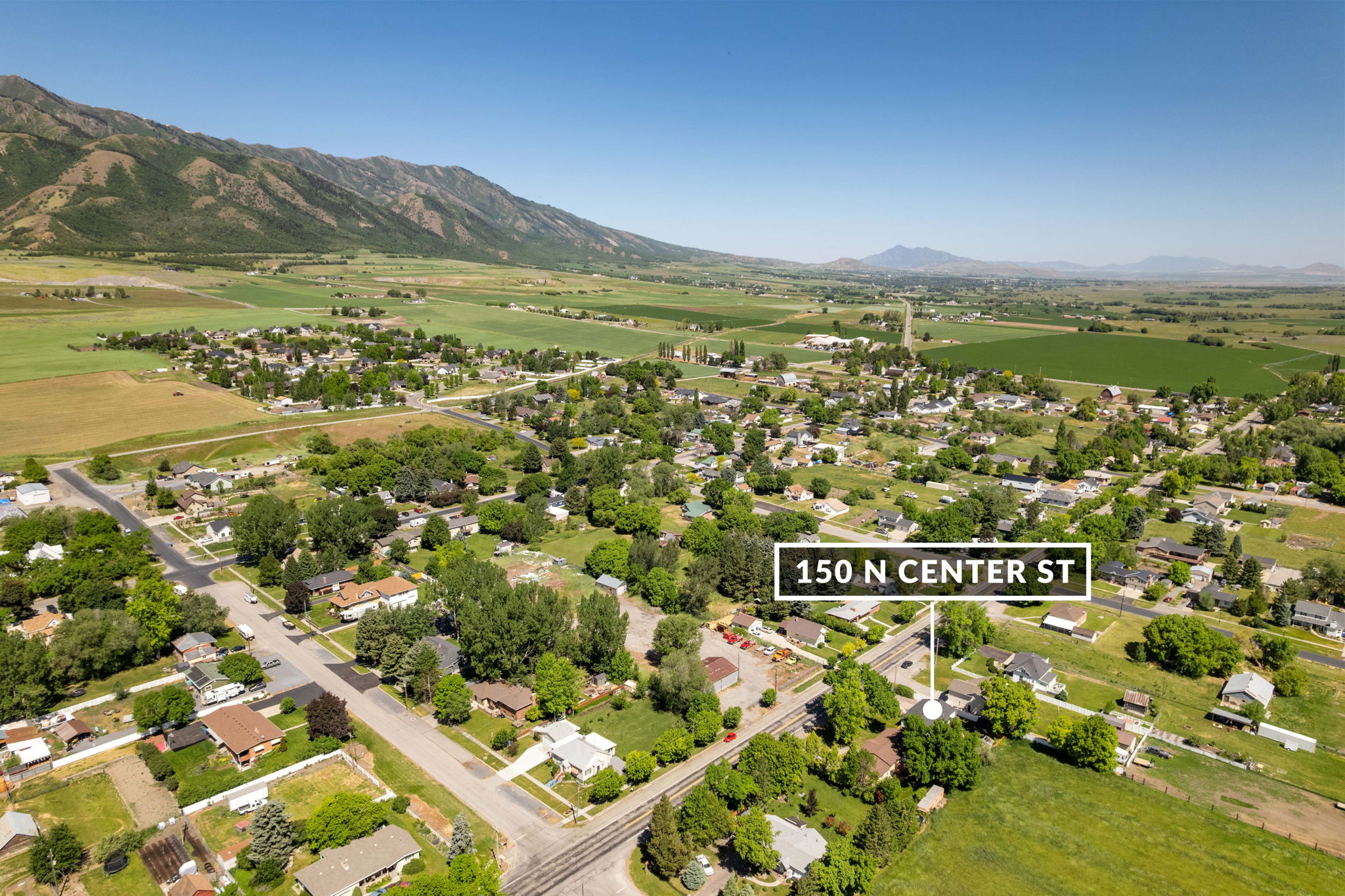 Aerial overview of a residential area set against a mountainous backdrop