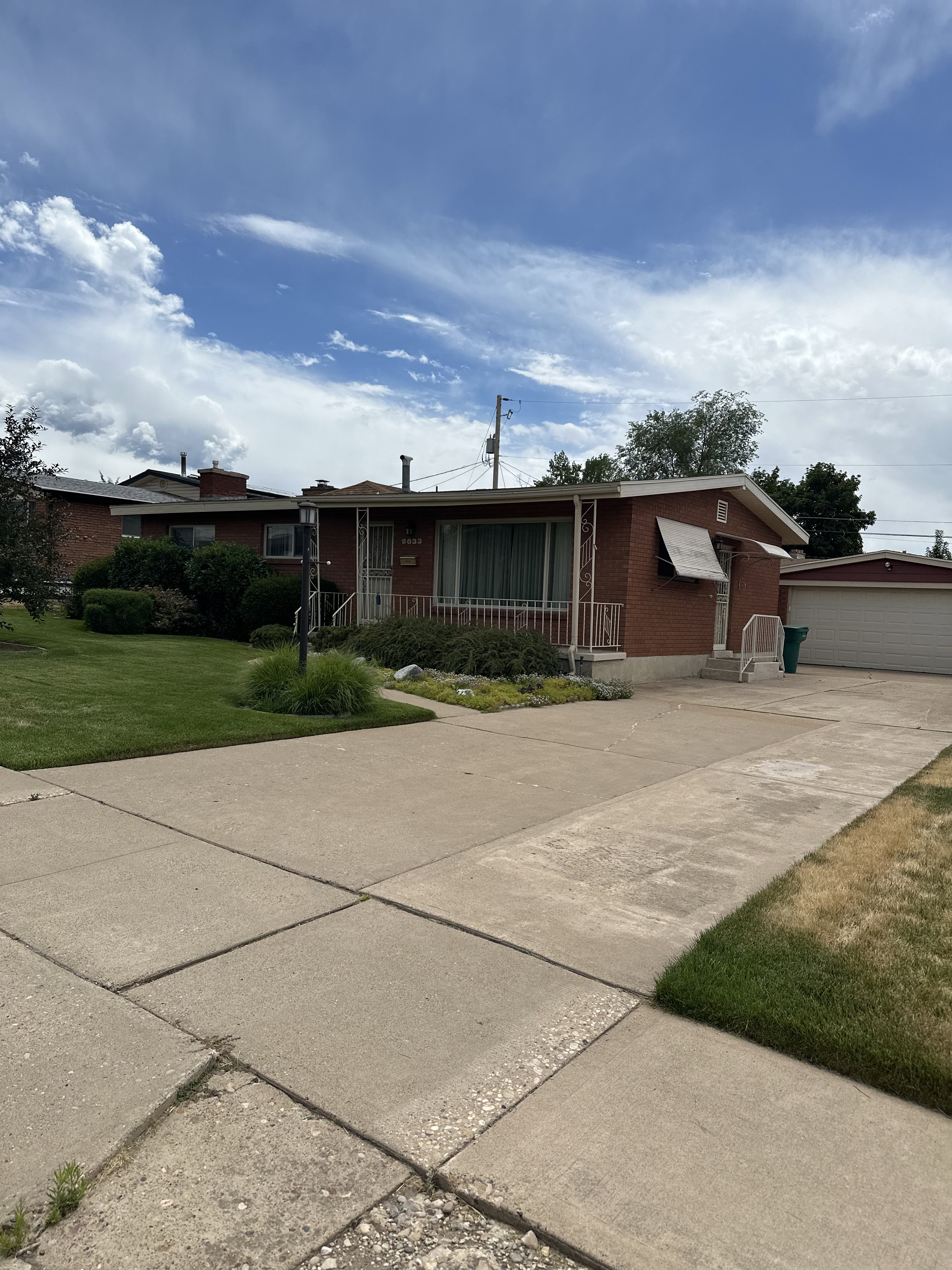 Brick exterior residence featuring an attached garage with a white door