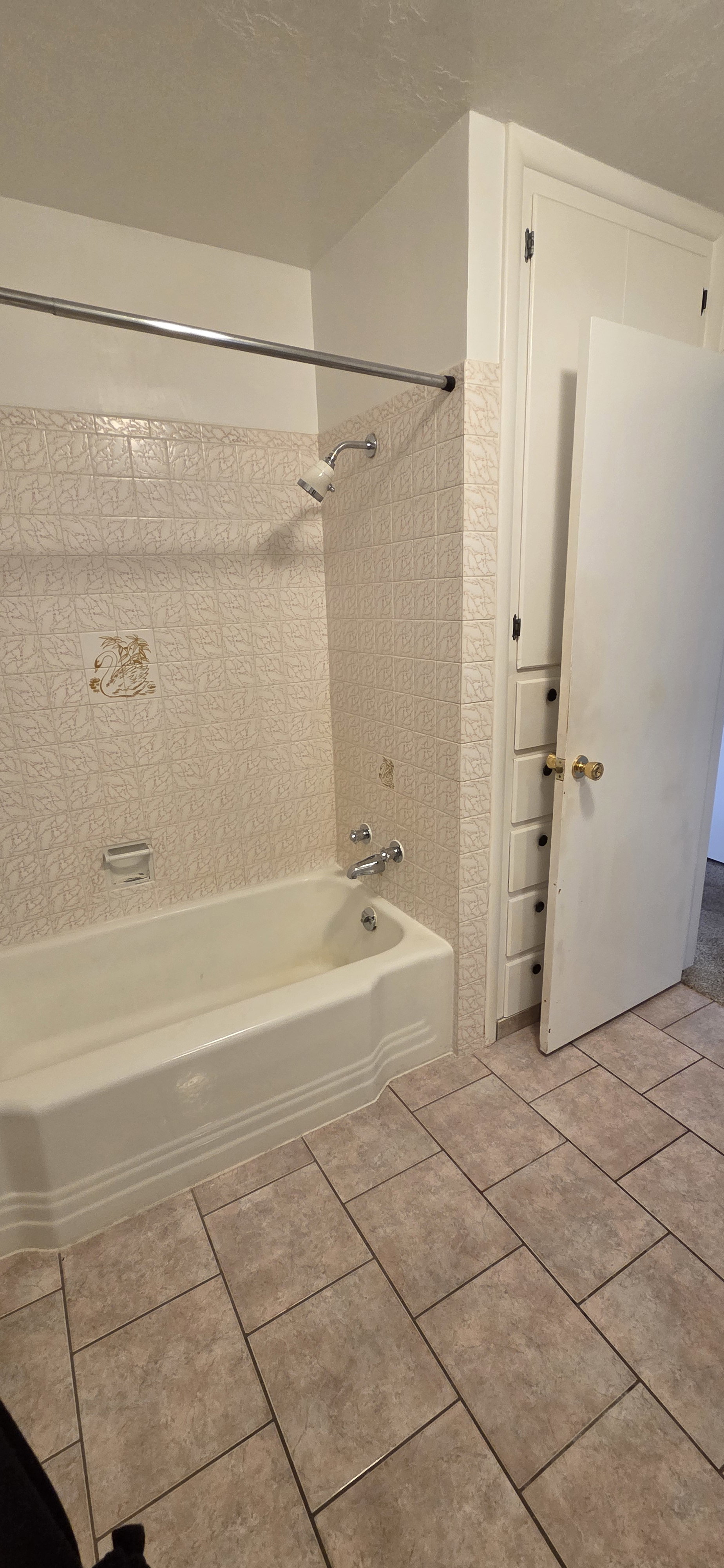 Bathroom featuring a built-in tub with a shower fixture