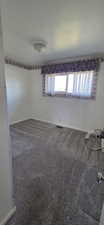 Room featuring neutral wall finishes and grey textured carpeting