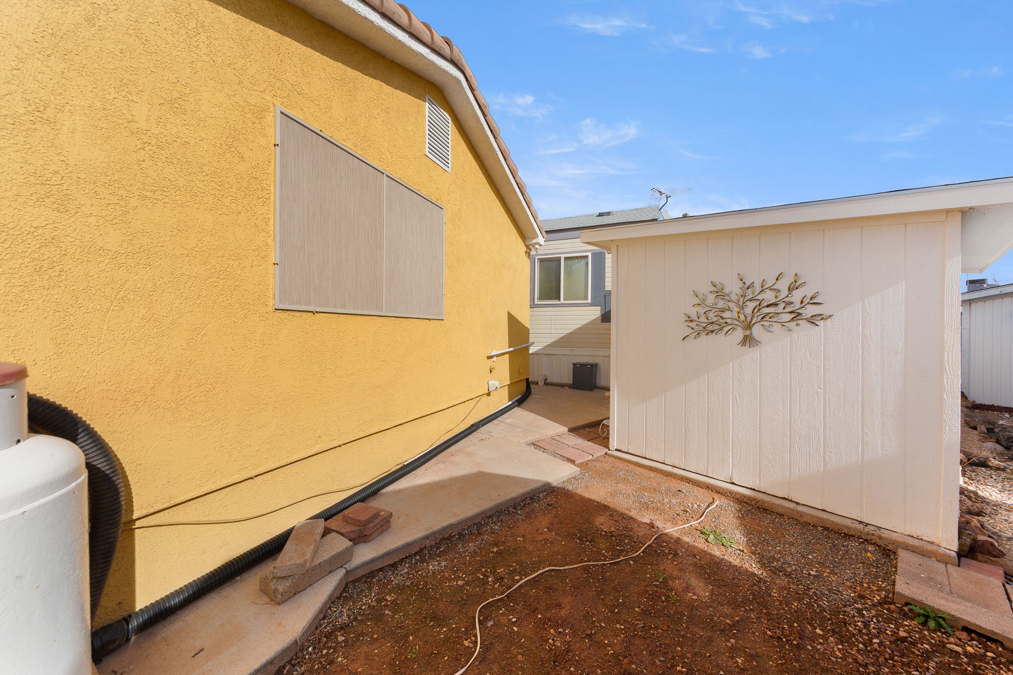Exterior stucco finish in a warm tone, featuring a terracotta tile roof line
