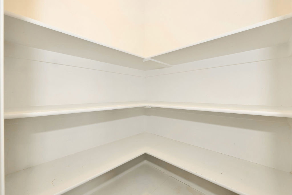 Corner built-in shelving with multiple storage levels and a neutral finish