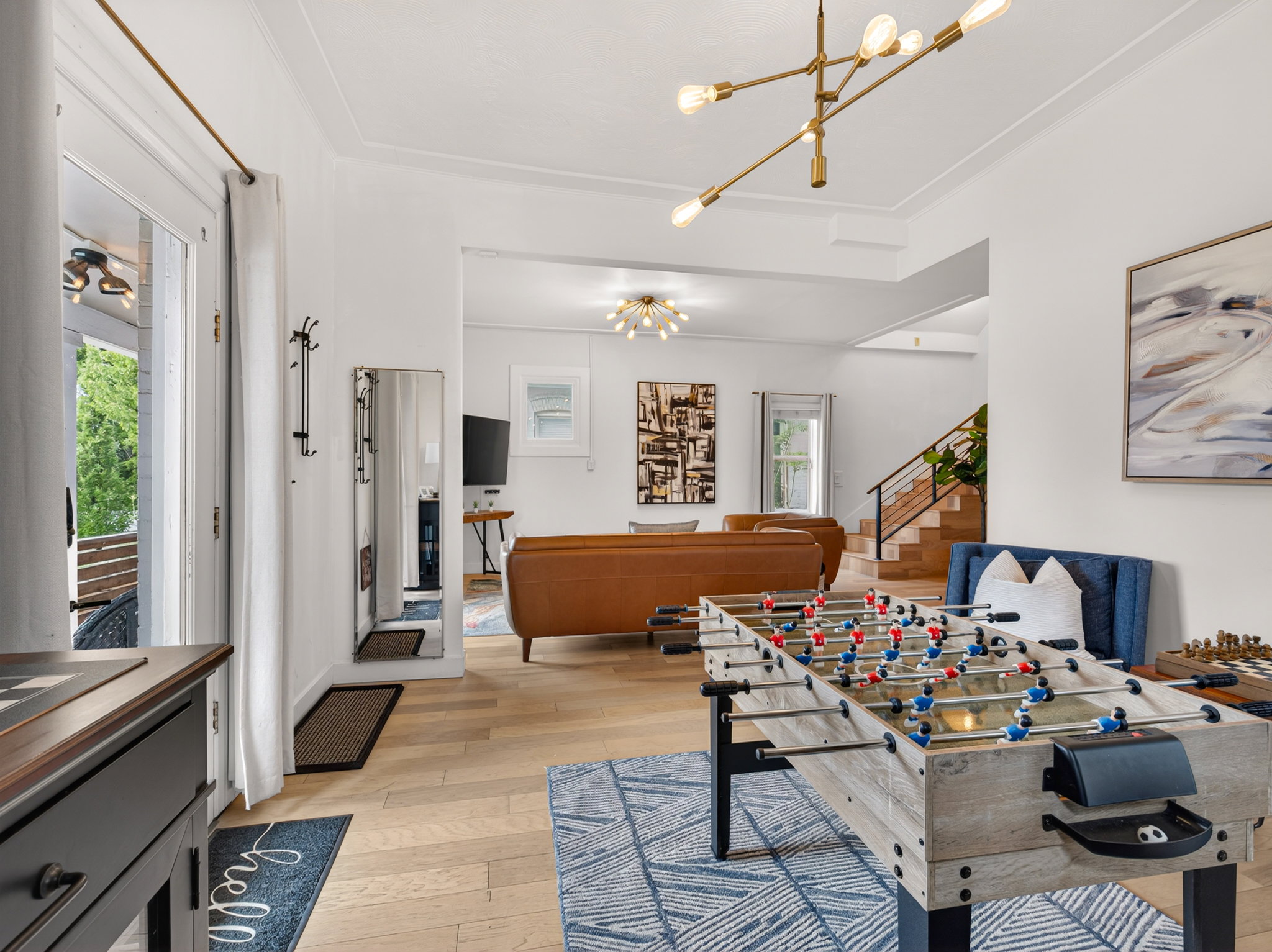 Open-concept living space with light wood-finish flooring