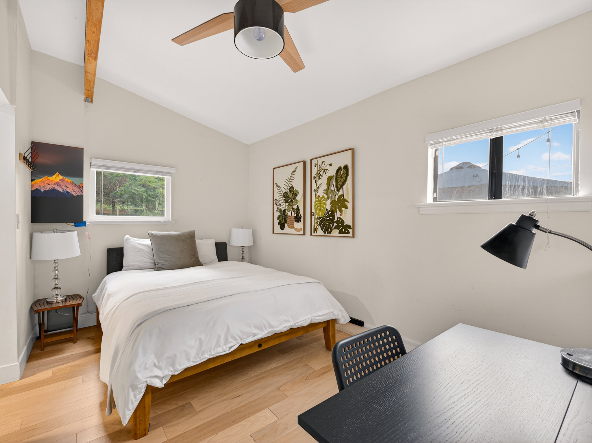 Vaulted ceiling with exposed wood beam and ceiling fan