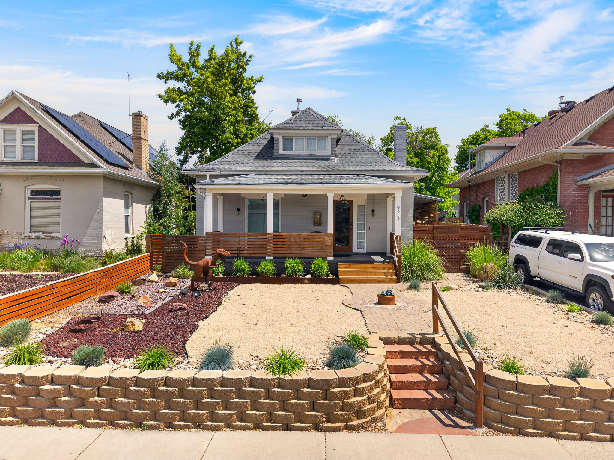 Light gray exterior with white columns and a dark gray roof