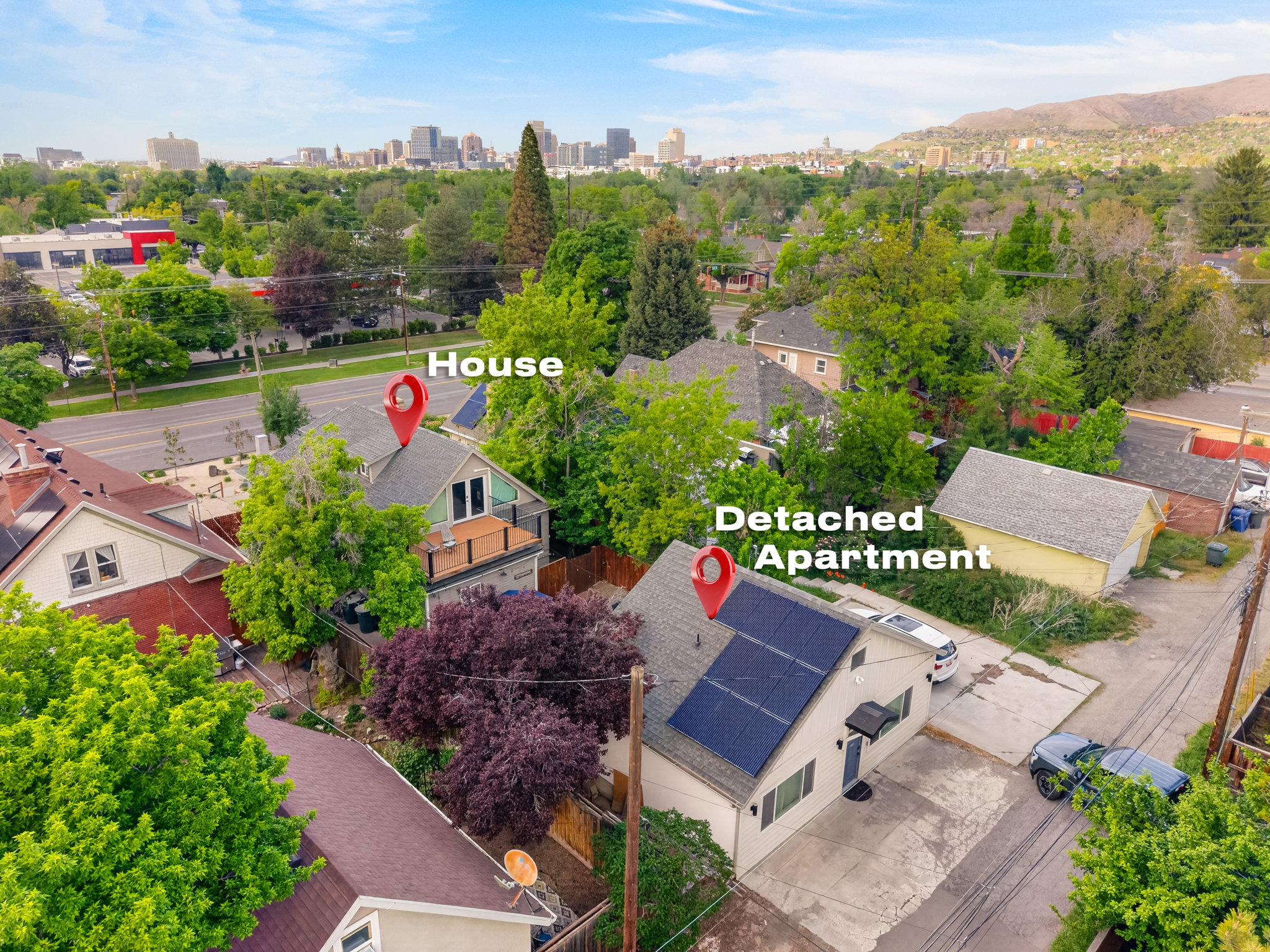 Property features a primary residence with an upper-level balcony and a separate detached apartment building