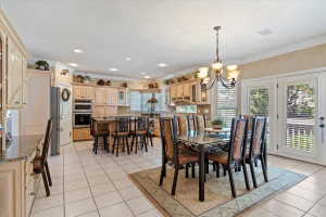 Spacious kitchen and dining area with tile flooring and a built-in desk