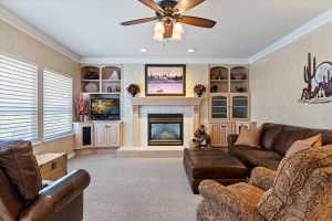 Living space featuring a central fireplace with a tile hearth and mantel, flanked by built-in cabinetry and shelving