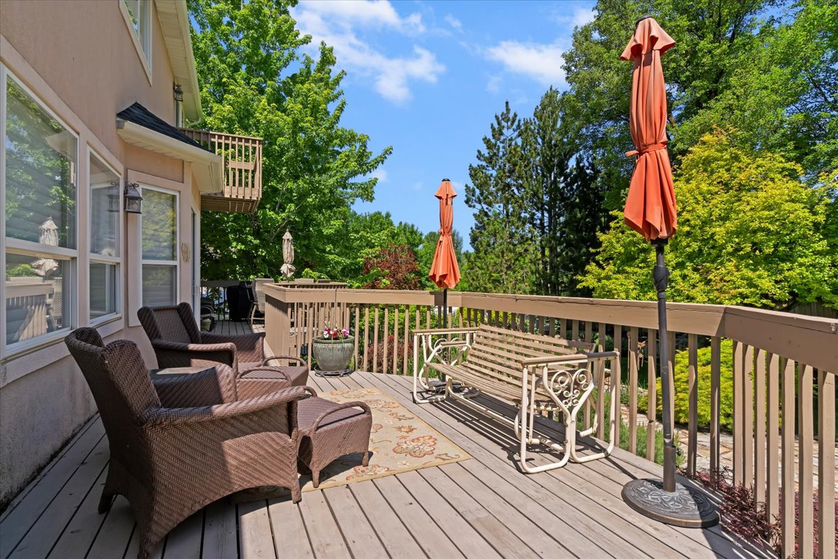 Spacious outdoor deck featuring wood-finish decking and perimeter railings