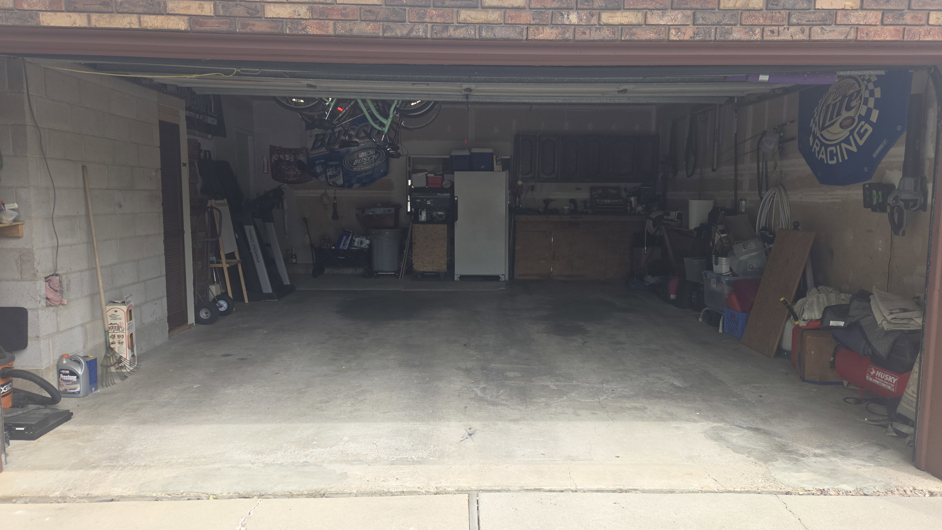 Two-car garage featuring a concrete floor and a side access door