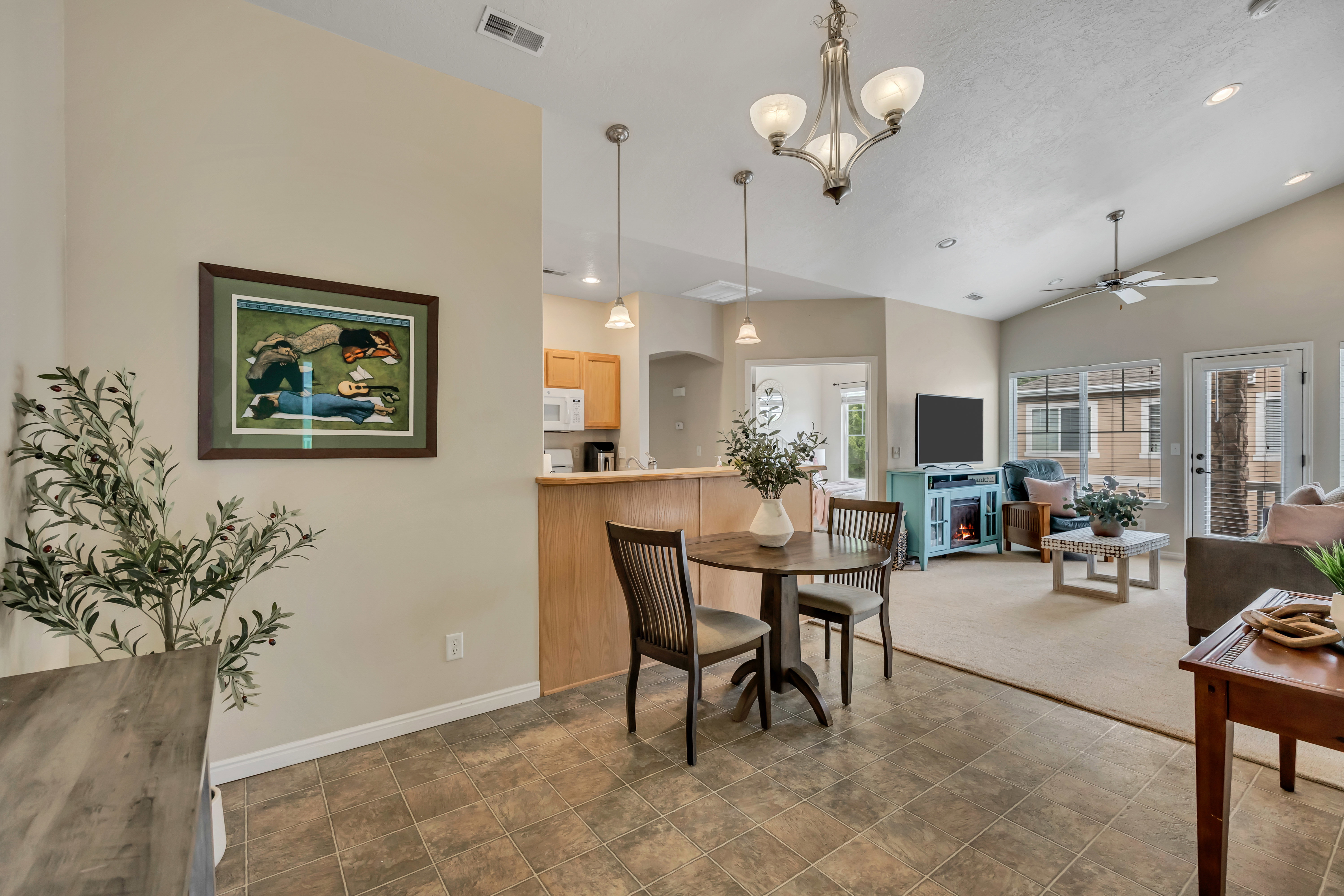 Open-concept living space with vaulted ceilings, recessed lighting, a ceiling fan, and great natural light.