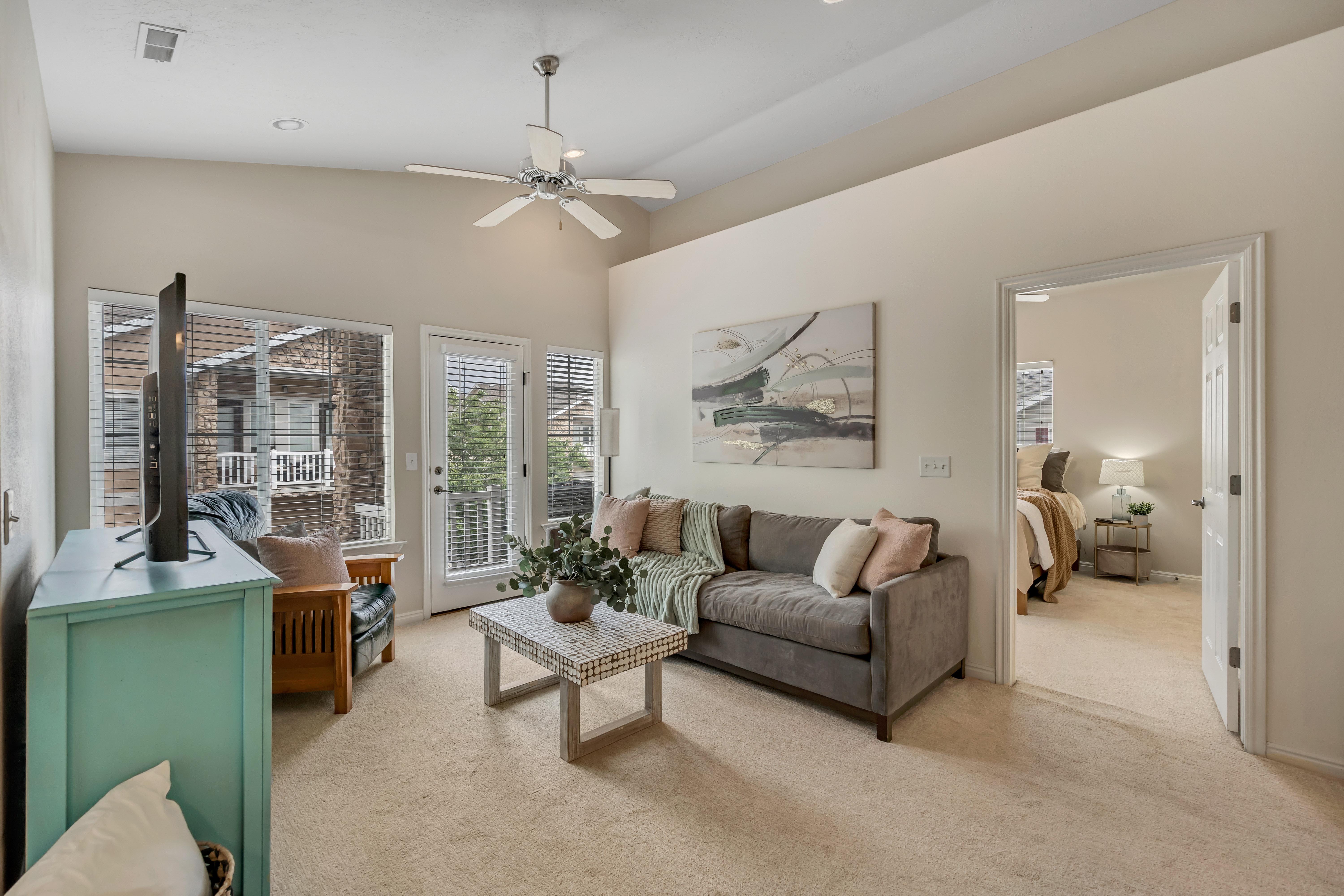 Living area featuring vaulted ceilings, recessed lighting, walkout to the deck, and freshly cleaned carpet flooring.