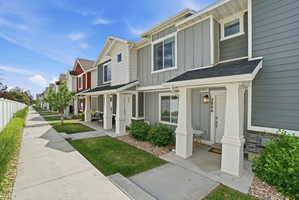 Row of modern townhomes featuring varying siding colors and gables