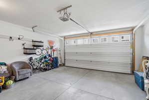 Spacious garage featuring a concrete floor and white walls