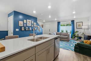 Kitchen island featuring a double-basin stainless steel sink and a gooseneck faucet
