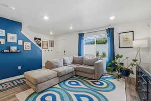 Living area featuring wood-finish flooring, recessed lighting, and a large sliding glass door