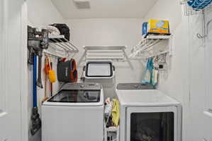 Dedicated laundry area featuring a top-load washing machine and a front-load dryer