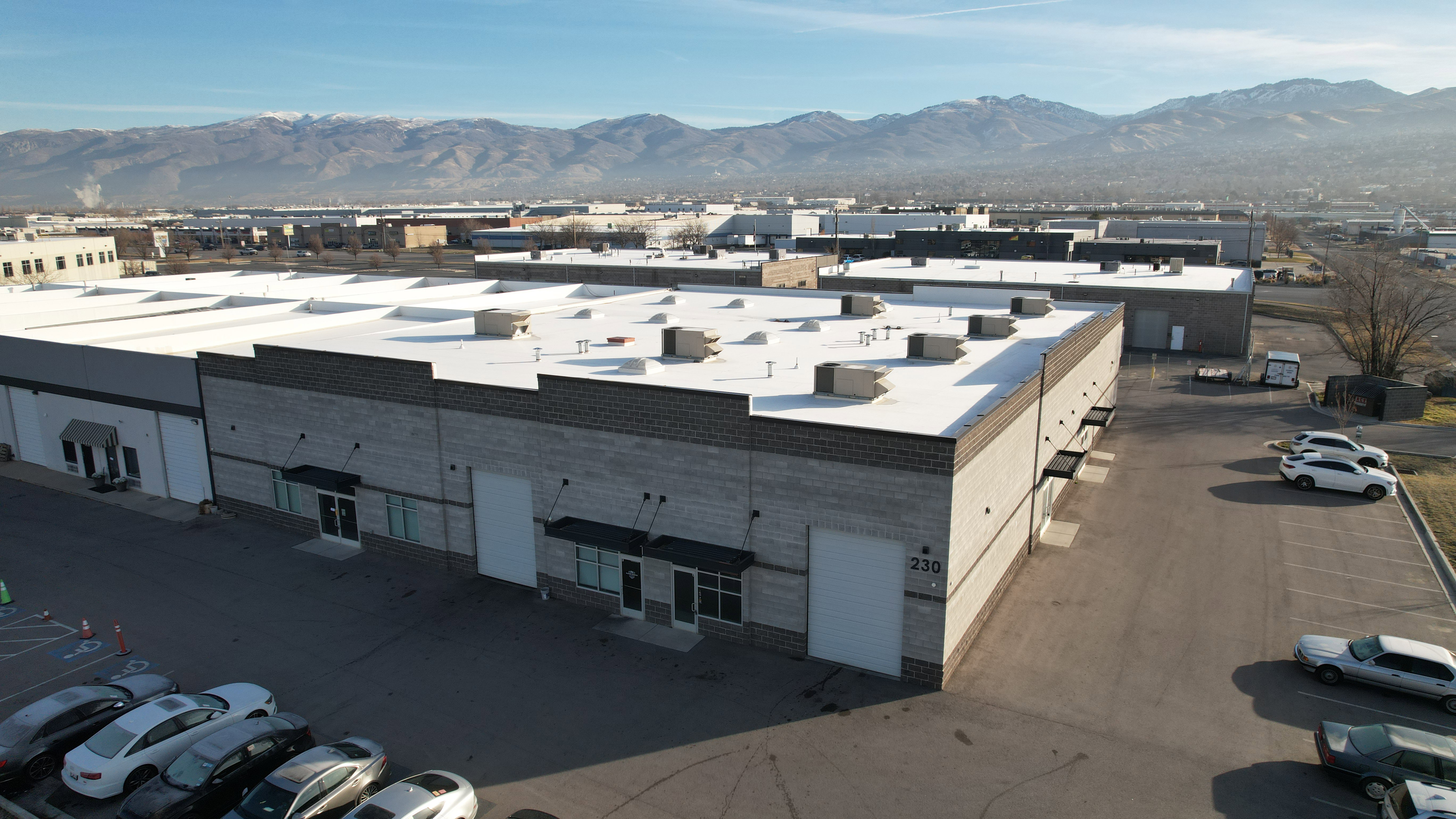 Commercial building with a light-colored flat roof and multiple rooftop units