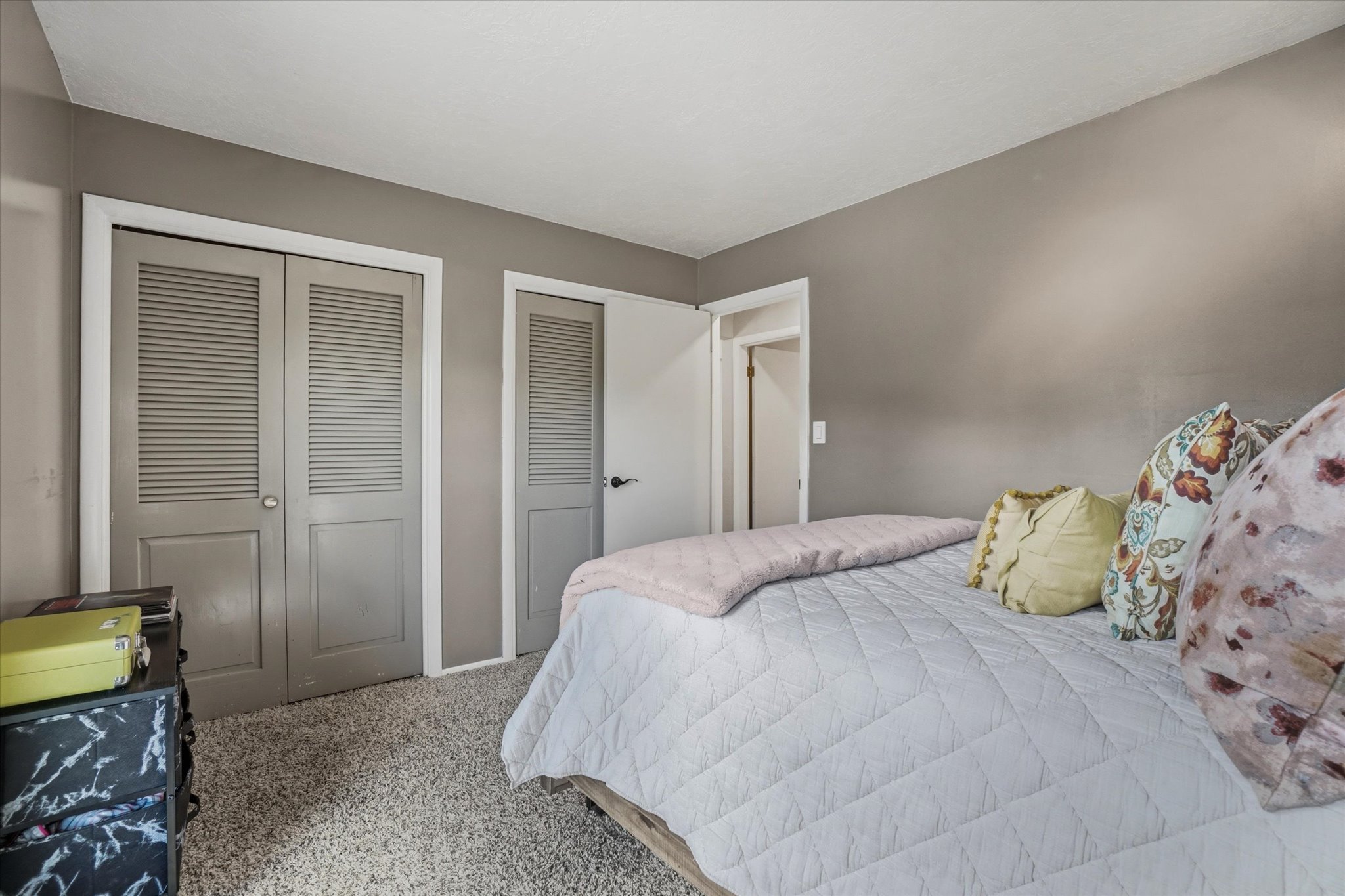 Wall-to-wall carpeting with painted walls and white trim