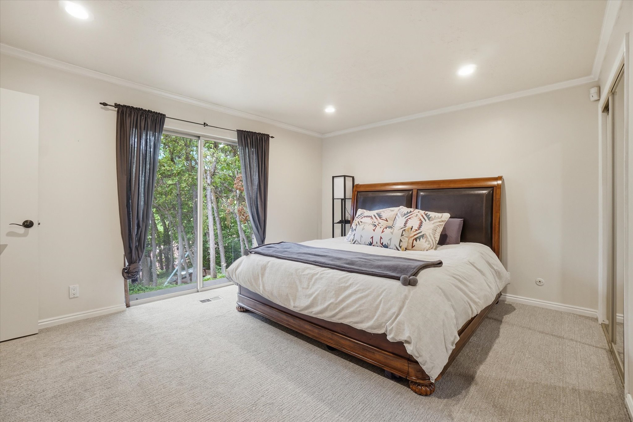 Light-colored wall finishes, crown molding, and recessed lighting