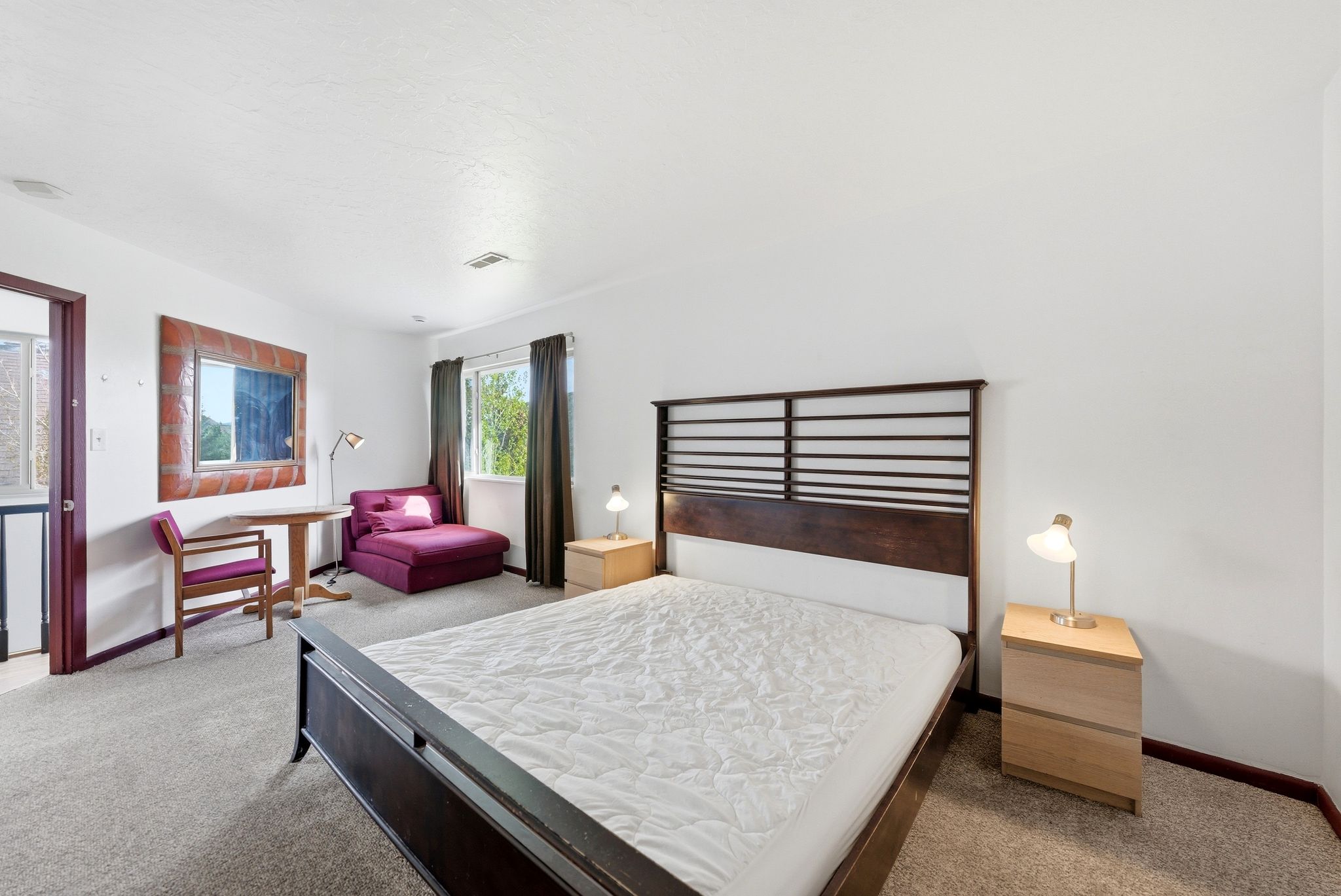 Spacious room featuring neutral carpeting and white walls