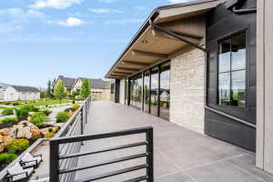 Expansive elevated patio featuring large format tile flooring and contemporary metal railings