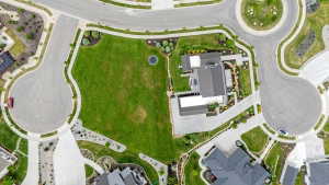 Aerial perspective showcasing a modern residence with a dark gray roof