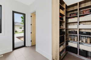 Spacious walk-in pantry with extensive wood-finish shelving