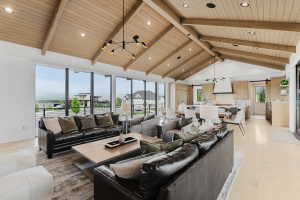 Vaulted tongue and groove wood plank ceiling with exposed beams
