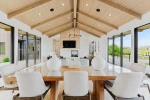 Vaulted wood-paneled ceiling with exposed beams and recessed lighting