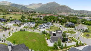Expansive residential development featuring a variety of architectural styles, surrounded by natural mountainous terrain