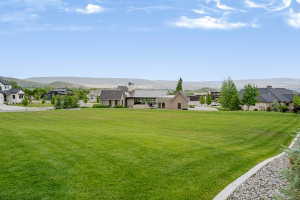 Expansive green lawn with mountain backdrop