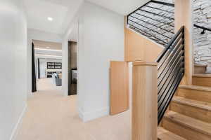 Crafted wood staircase with a sleek black iron railing