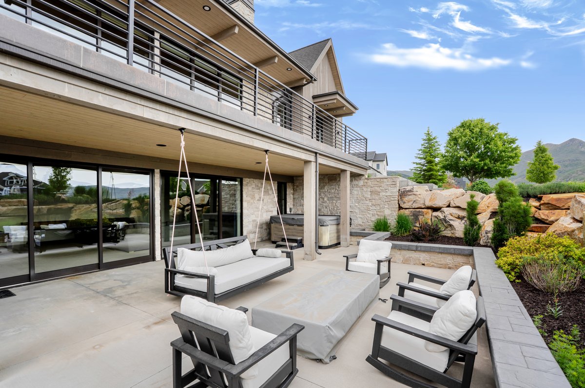 Spacious outdoor patio with direct access via multiple sliding glass doors