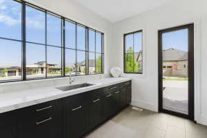 Expansive wall of black-framed grid windows, offering abundant natural light
